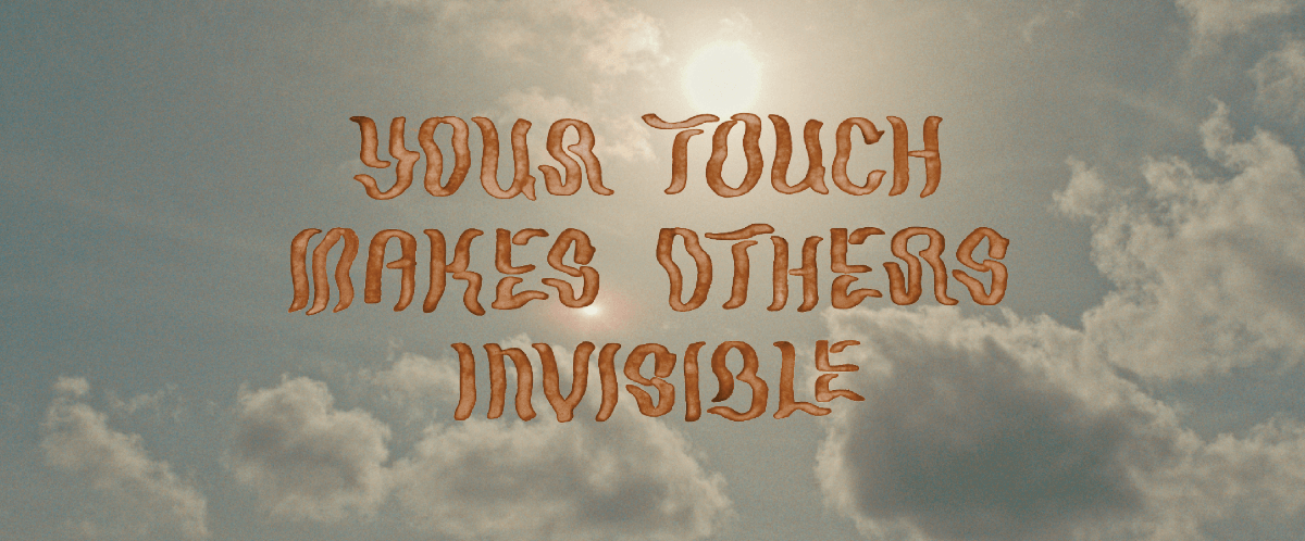 A film still reading Your Touch Makes Others Invisible in clay-like lettering on top of a sky